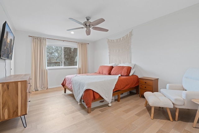 bedroom featuring ceiling fan and light hardwood / wood-style flooring