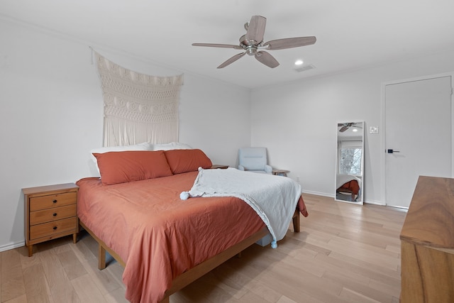 bedroom with ceiling fan and light hardwood / wood-style flooring