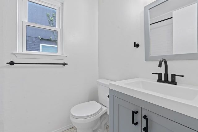 bathroom featuring vanity, plenty of natural light, and toilet