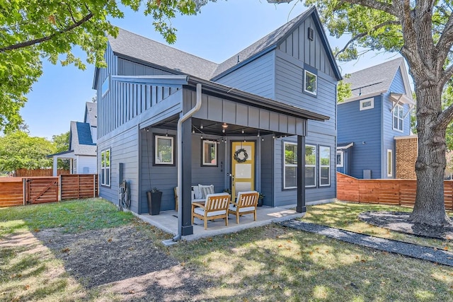 back of house featuring a patio and a lawn