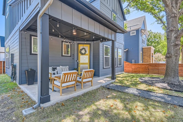 back of property with a patio area, outdoor lounge area, and a yard