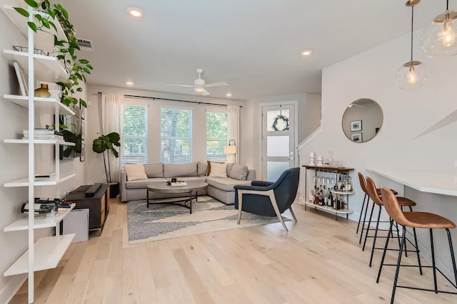 living room featuring ceiling fan and light hardwood / wood-style flooring