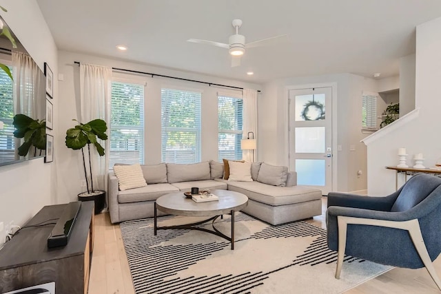 living room featuring light hardwood / wood-style floors and ceiling fan