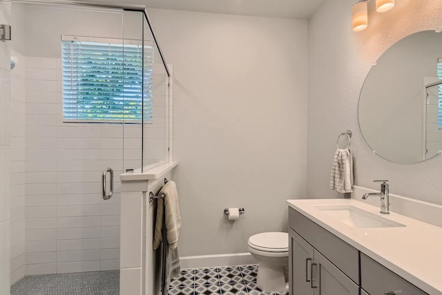 bathroom with toilet, a shower with door, vanity, and tile patterned flooring