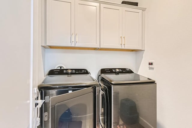 laundry area featuring cabinets and separate washer and dryer