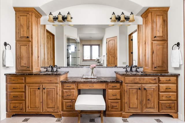 bathroom featuring vanity, tile patterned floors, and vaulted ceiling