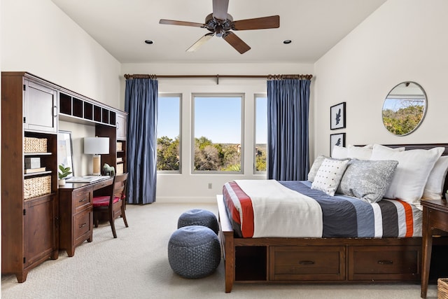 bedroom with ceiling fan and light colored carpet