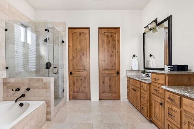 bathroom with independent shower and bath and vanity