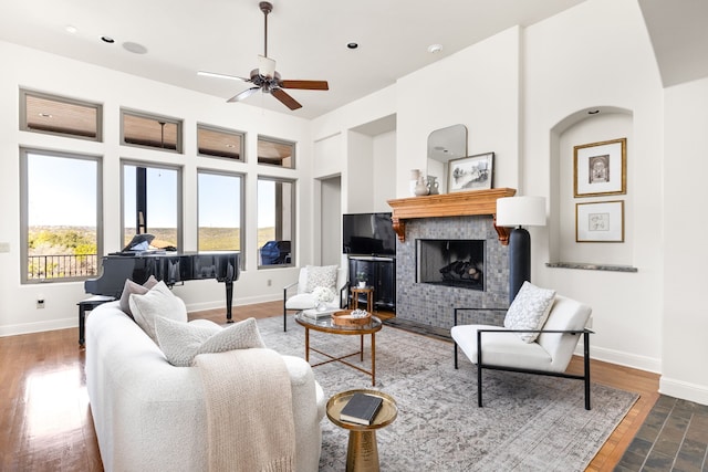 living room featuring ceiling fan and dark hardwood / wood-style floors