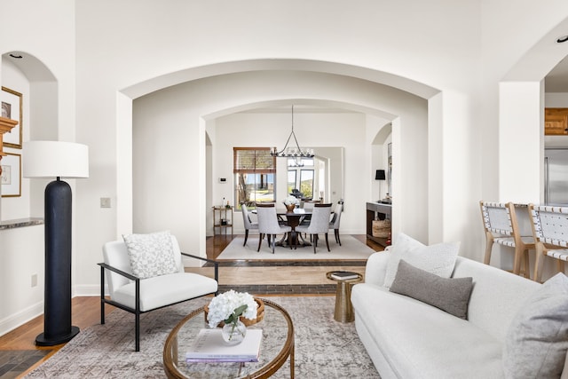 living room with hardwood / wood-style flooring and a notable chandelier