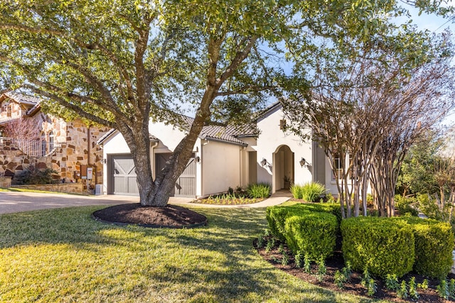 view of front of property with a front lawn and a garage