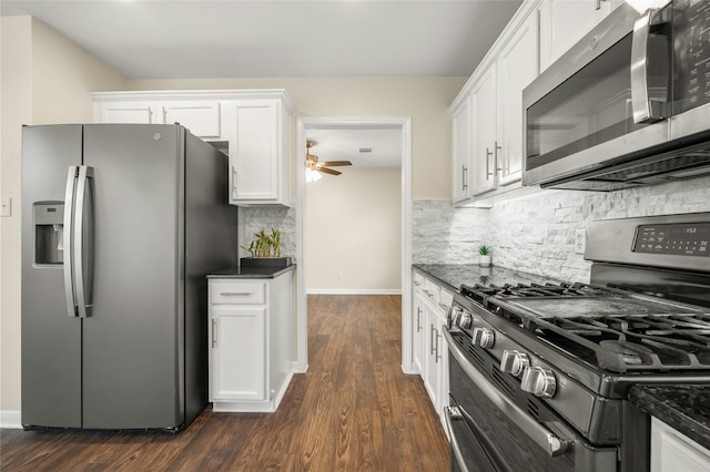 kitchen with dark wood-type flooring, stainless steel appliances, tasteful backsplash, white cabinets, and ceiling fan