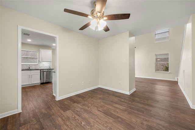 spare room featuring ceiling fan, dark hardwood / wood-style flooring, and sink