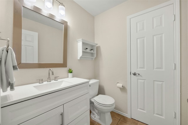 bathroom featuring toilet, vanity, and tile patterned floors