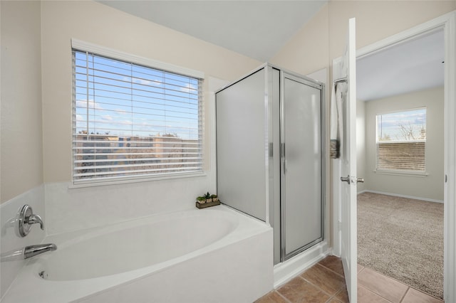 bathroom featuring plus walk in shower and tile patterned floors