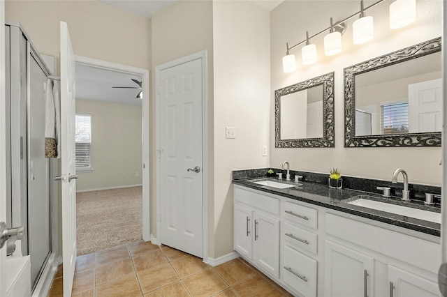 bathroom featuring ceiling fan, walk in shower, tile patterned floors, and vanity