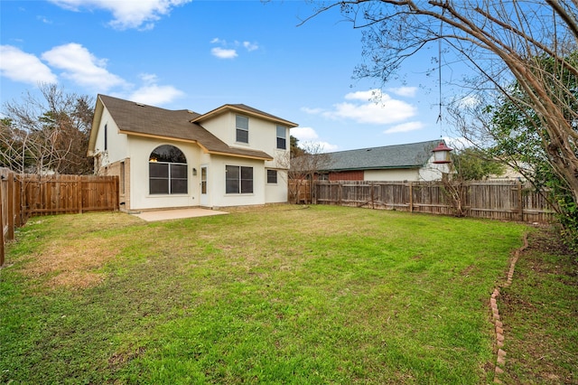 back of property featuring a lawn and a patio area