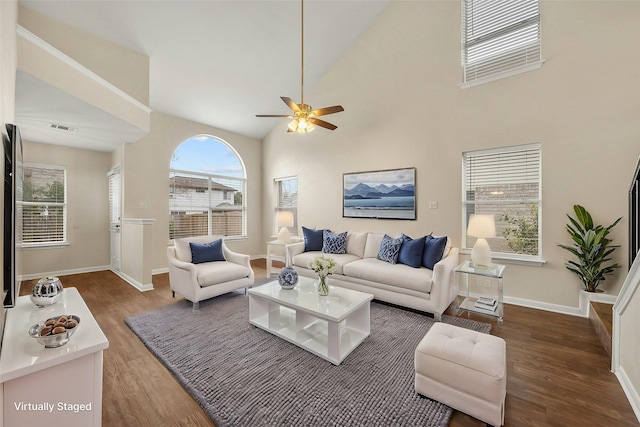 living room featuring high vaulted ceiling, ceiling fan, and dark hardwood / wood-style floors