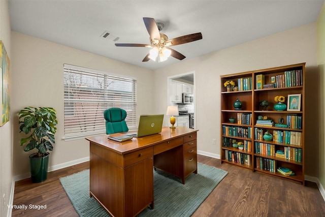 office space with ceiling fan and dark hardwood / wood-style floors