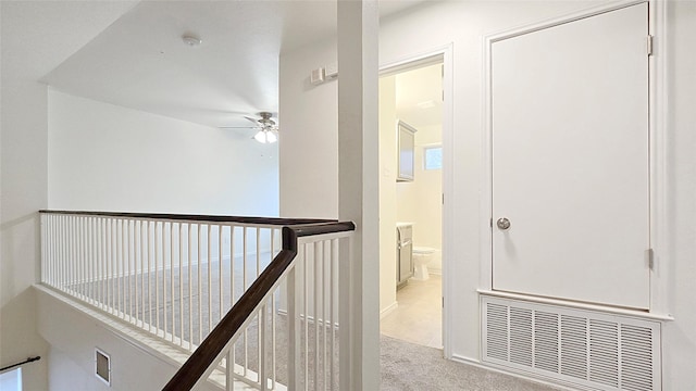 corridor featuring light colored carpet