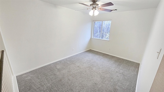 carpeted spare room featuring ceiling fan