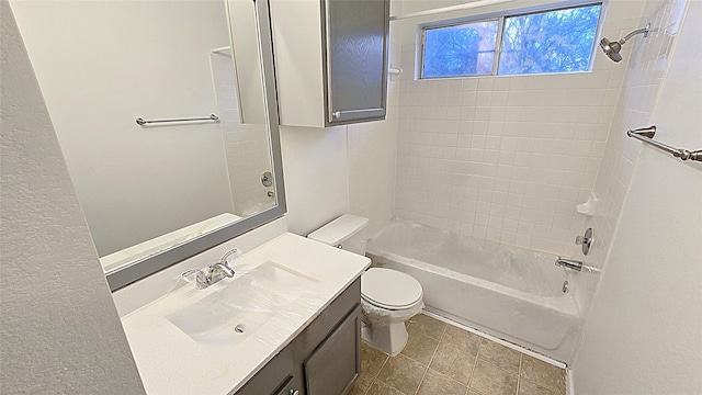 full bathroom with tiled shower / bath, vanity, and toilet