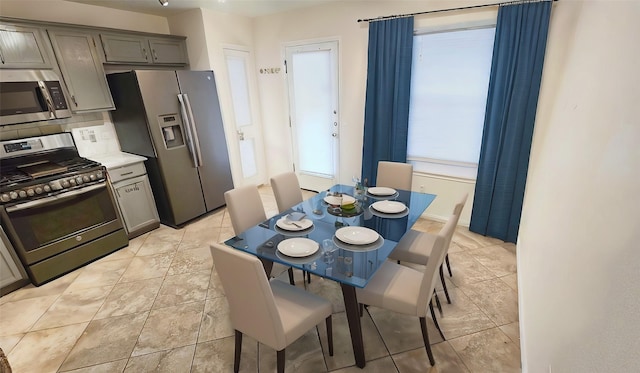 dining area with plenty of natural light and light tile patterned floors