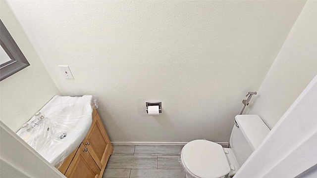 bathroom featuring toilet and vanity