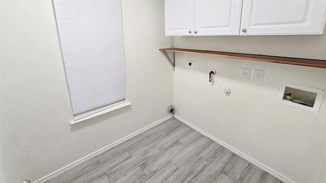 washroom with cabinets, light hardwood / wood-style floors, washer hookup, electric dryer hookup, and gas dryer hookup