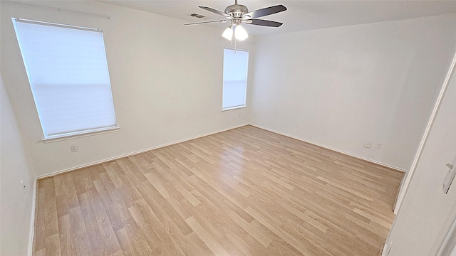 empty room featuring ceiling fan and light hardwood / wood-style floors