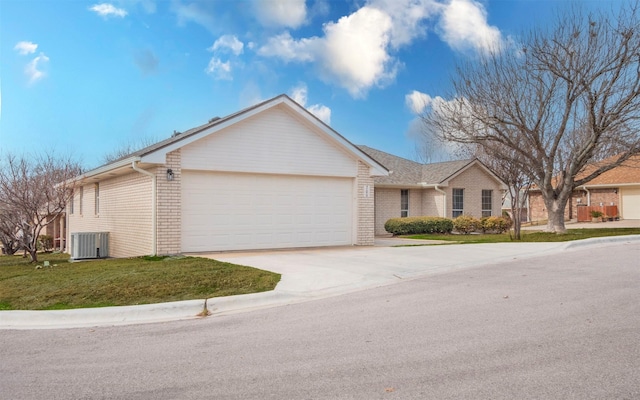 ranch-style house featuring a front yard, central AC unit, and a garage