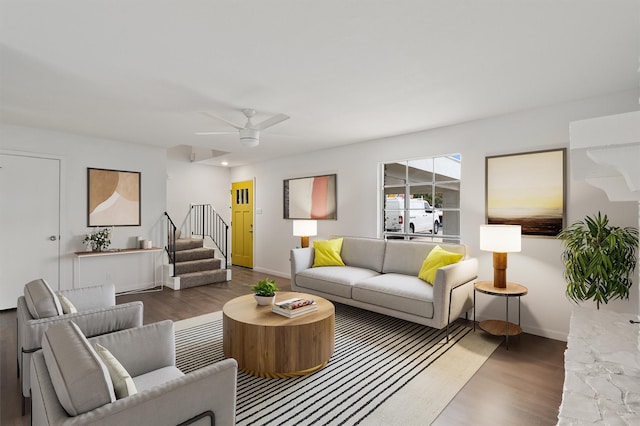 living room with ceiling fan and dark wood-type flooring