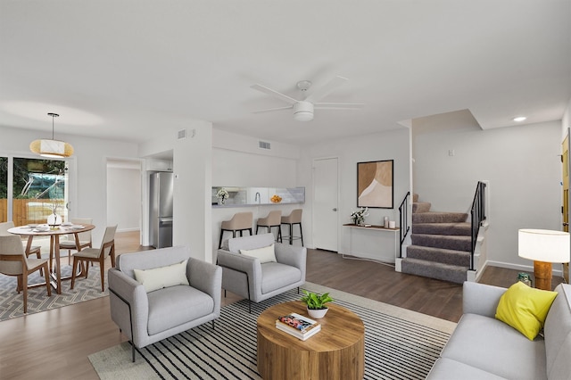 living room with dark wood-type flooring and ceiling fan