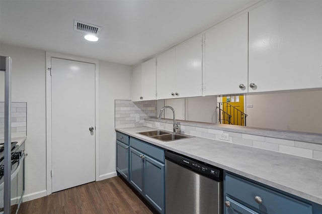 kitchen with appliances with stainless steel finishes, blue cabinetry, white cabinets, and sink