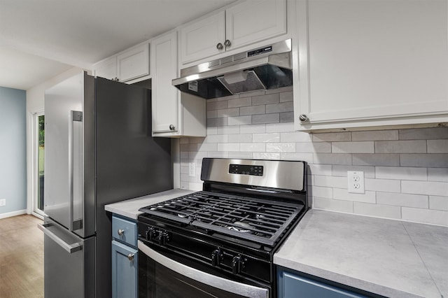 kitchen featuring light hardwood / wood-style flooring, stainless steel appliances, decorative backsplash, blue cabinets, and white cabinets