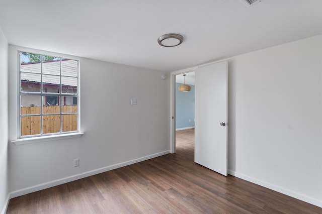 unfurnished room featuring dark hardwood / wood-style floors