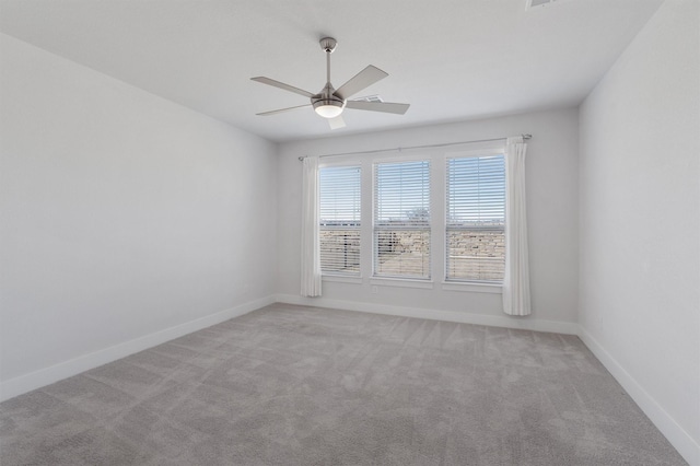 unfurnished room featuring ceiling fan and light carpet