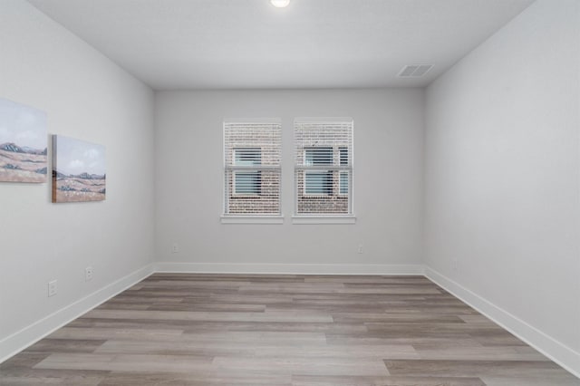 spare room featuring light wood-type flooring