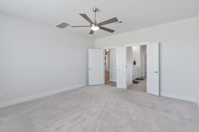 unfurnished bedroom featuring ceiling fan and light carpet