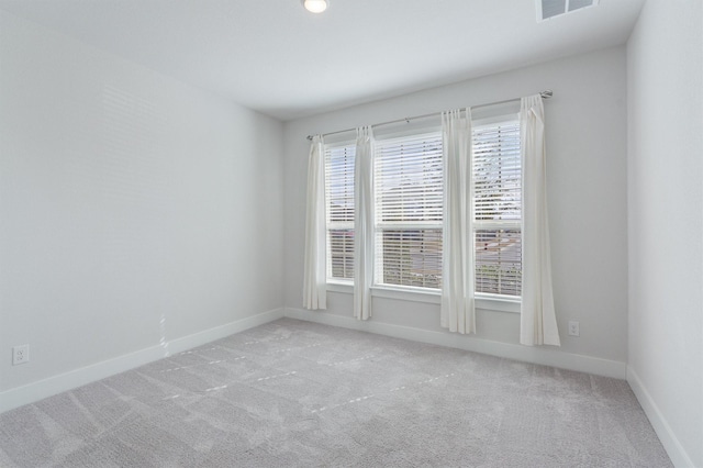 unfurnished room with light carpet