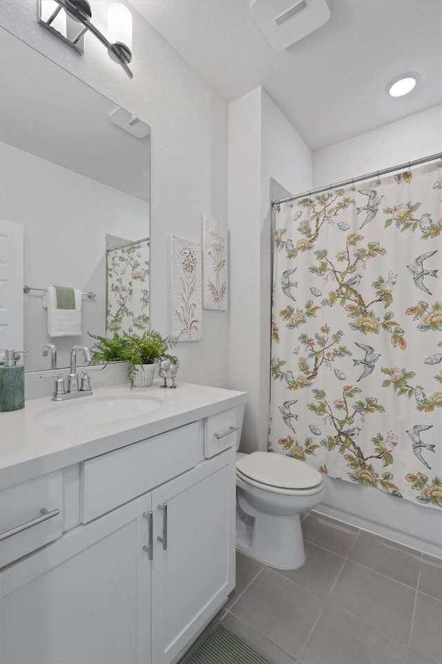 full bathroom featuring toilet, vanity, tile patterned flooring, and shower / bathtub combination with curtain