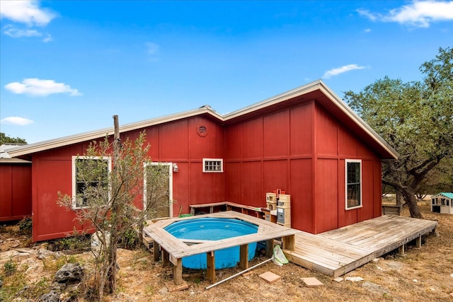 back of property featuring a wooden deck