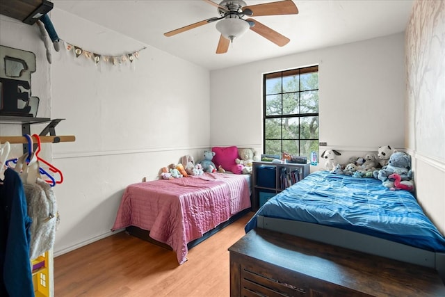 bedroom with ceiling fan and wood-type flooring