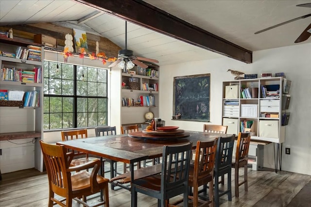 dining space with vaulted ceiling with beams, wood finished floors, and a ceiling fan