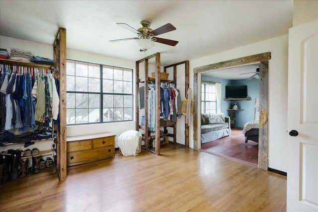 bedroom featuring ceiling fan, baseboards, and wood finished floors