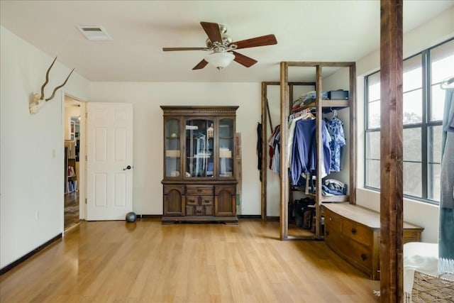 mudroom featuring visible vents, ceiling fan, light wood-style flooring, and baseboards