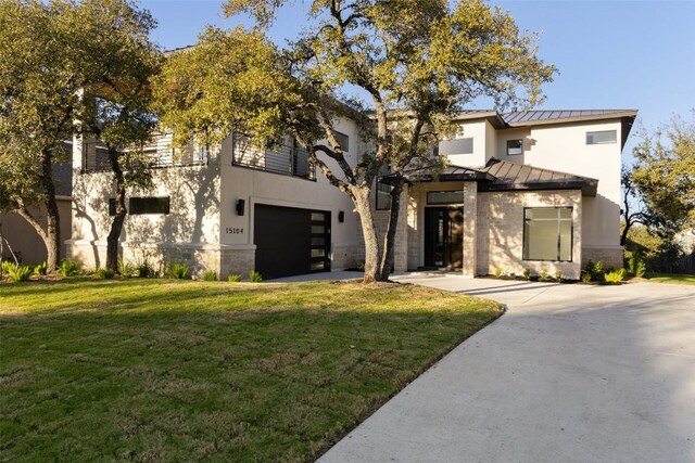 view of front of property with a front yard and a garage