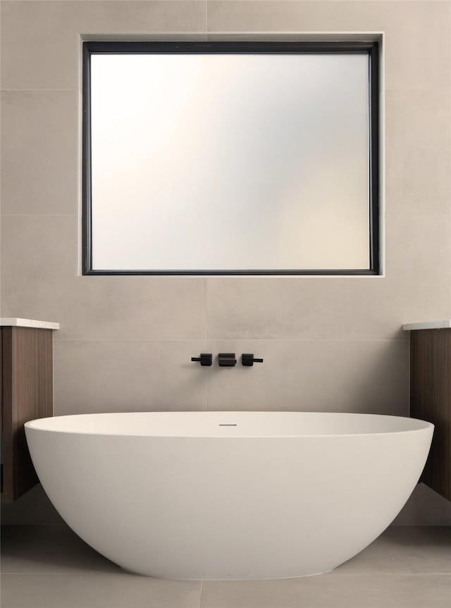 bathroom with tile walls and a washtub