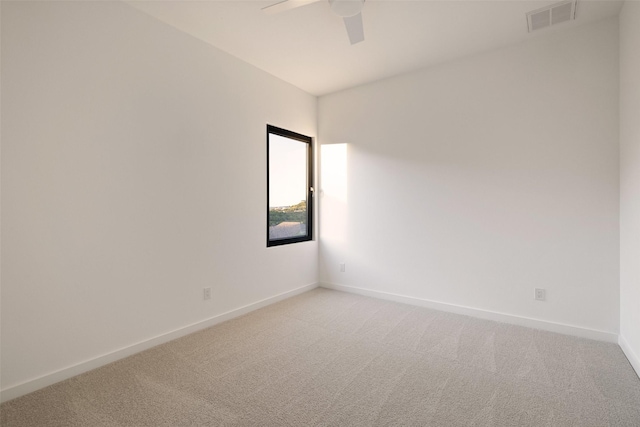 unfurnished room featuring ceiling fan and carpet