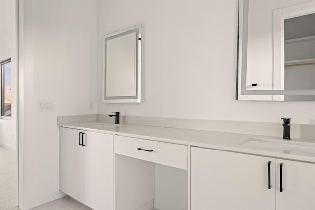 bathroom with tile patterned floors and vanity